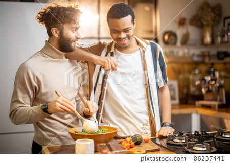 Two guys cooking healthy together at home Two guys cooking healthy together at home 86237441