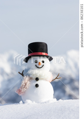 Snowman in snowy mountains and top hat 86238101