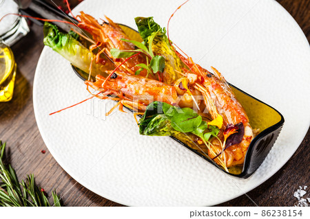 Argentinian king prawns, glazed. Lime, chilly and garlic. Served in a bottle. Delicious healthy traditional food closeup served for lunch in modern gourmet cuisine restaurant Argentinian king prawns, glazed. Lime, chilly and garlic. Served in a bottle. Delicious healthy traditional food closeup served for lunch in modern gourmet cuisine restaurant 86238154