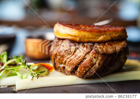 Tournedos Rossini. Foie gras, Black Angus beef tenderloin, white asparagus, red wine sauce. Delicious healthy traditional food closeup served for lunch in modern gourmet cuisine restaurant 86238177
