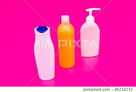 Ideal for your toiletries. Plastic bottles pink background. Multicolor toiletry bottles. HDPE Ideal for your toiletries. Plastic bottles pink background. Multicolor toiletry bottles. HDPE 86238232