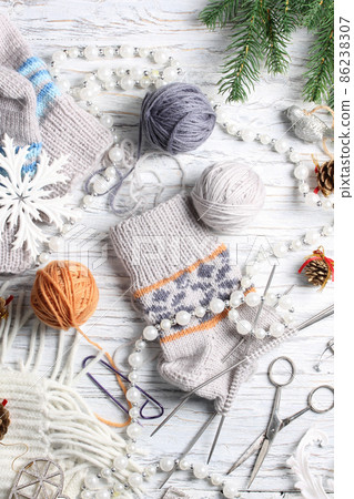 Flat lay of knitting and winter accessories on white background Flat lay of knitting and winter accessories on white background 86238307