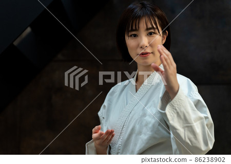 A woman preparing for karate 86238902