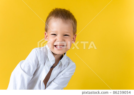 Banner Funny Preschool Child Boy in unbuttoned shirt smile narrow eye on Yellow Background Copy Space. Happy Smiling Kid Go Back to School, Kindergarten. Success, Motivation, Genius, Superhero concept Banner Funny Preschool Child Boy in unbuttoned shirt smile narrow eye on Yellow Background Copy Space. Happy Smiling Kid Go Back to School, Kindergarten. Success, Motivation, Genius, Superhero concept 86239054