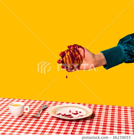 Food pop art photography. Female hand and sweet pancakes on plaid tablecloth isolated on bright yellow background. Vintage, retro style 86239055