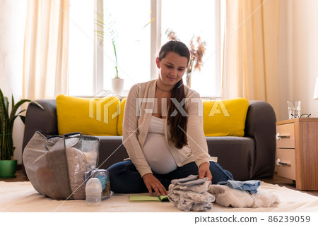 Cute Pregnant Woman Writing Packing List For Maternity Hospital Notebook Prepares Bag. Young Ledy In Pregnancy Have Fun Spend Time On Floor Near Sofa At Home. Motherhood, Medicine Health Care Concept Cute Pregnant Woman Writing Packing List For Maternity Hospital Notebook Prepares Bag. Young Ledy In Pregnancy Have Fun Spend Time On Floor Near Sofa At Home. Motherhood, Medicine Health Care Concept 86239059