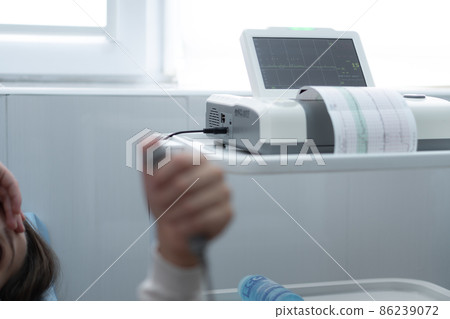 Close Up Pregnant Woman On Hospital Couch During Medical Control Cardiotocography. Visit Gynecologist Doctor At Clinic For Pregnancy Consultant. Examine Expectant Belly Baby Mother Healthcare Check Up Close Up Pregnant Woman On Hospital Couch During Medical Control Cardiotocography. Visit Gynecologist Doctor At Clinic For Pregnancy Consultant. Examine Expectant Belly Baby Mother Healthcare Check Up 86239072