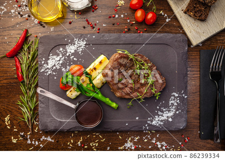 Black Angus New York steak. Marbled beef sirloin from Uruguay. Delicious healthy traditional food closeup served for lunch in modern gourmet cuisine restaurant 86239334