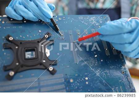 Repairman diagnosing breakdown in computer motherboard using tester closeup Repairman diagnosing breakdown in computer motherboard using tester closeup 86239985
