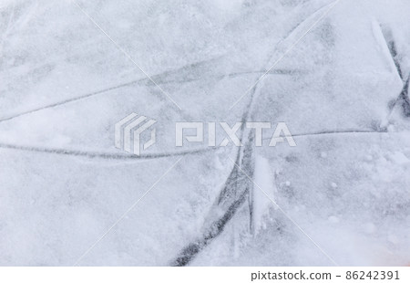 Ice background with marks from skating and hockey, blue texture of rink surface with many scratches Ice background with marks from skating and hockey, blue texture of rink surface with many scratches 86242391