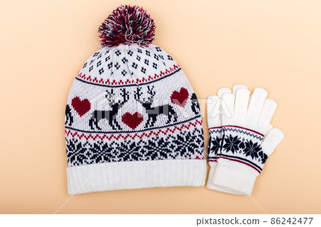 Gloves and worm woolen hat. winter set on orange background 86242477