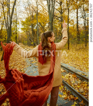 Fashion young woman walking through autumn park Fashion young woman walking through autumn park 86242787