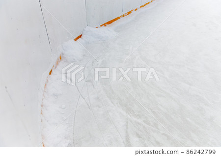 Ice background with marks from skating and hockey, blue texture of rink surface with many scratches Ice background with marks from skating and hockey, blue texture of rink surface with many scratches 86242799