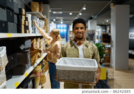 Man buying wicker basket standing in shop Man buying wicker basket standing in shop 86242885