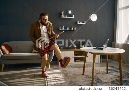 Funny freelance businessman playing broom like guitar Funny freelance businessman playing broom like guitar 86243312