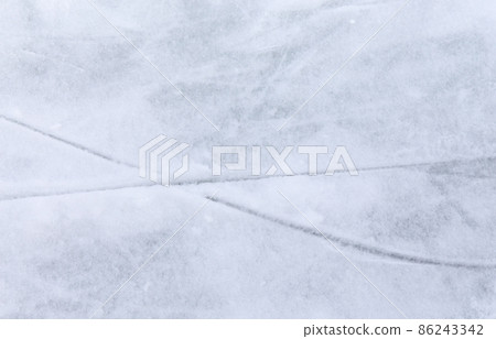 Ice background with marks from skating and hockey, blue texture of rink surface with many scratches 86243342