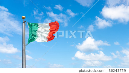 Flag of Italy over a blue sky with clouds 86243759