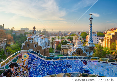 Barcelona city view from Guell Park. Sunrise view of colorful mosaic building in Park Guell Barcelona city view from Guell Park. Sunrise view of colorful mosaic building in Park Guell 86243810