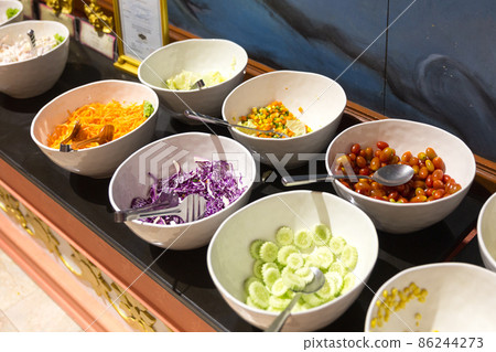 Variety of fresh salads in a buffet Variety of fresh salads in a buffet 86244273
