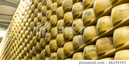 Parmigiano Cheese factory with the aging cheese Parmigiano Cheese factory with the aging cheese 86244345