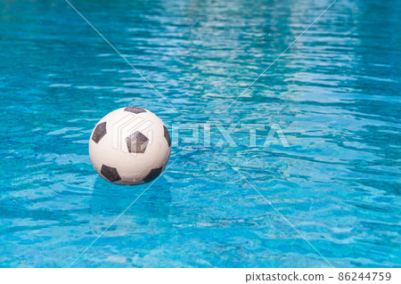 Soccer ball floating in the swimming pool Soccer ball floating in the swimming pool 86244759