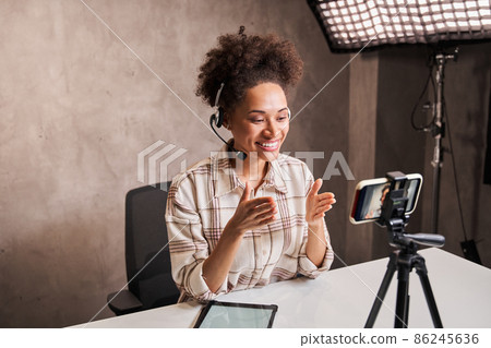Smiling attractive female blogger talking to camera to her subscribers 86245636