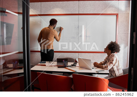 Attractive young colleagues are working together in office Attractive young colleagues are working together in office 86245962