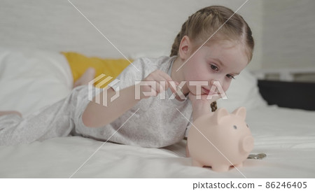 little child put money piggy bank, collect cash coins bank, save money success, wealth financial savings idea, small business spending management, toddler manual, counting earnings bills for future little child put money piggy bank, collect cash coins bank, save money success, wealth financial savings idea, small business spending management, toddler manual, counting earnings bills for future 86246405