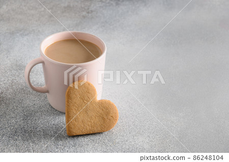 Valentine's Day coffee and heart shaped cookie for breakfast. Valentine's Day coffee and heart shaped cookie for breakfast. 86248104