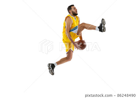 Dynamic portrait of professional basketball player jumping with ball isolated on white studio background. Sport, motion, activity, movement concepts. 86248490