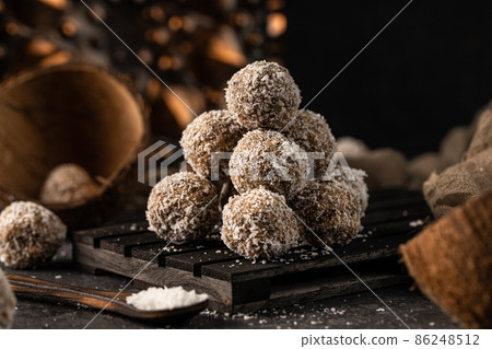 still life photo of healthy, homemade, delicious sweets. Tasty lactose and sugar free coconut balls with healthy ingredients 86248512