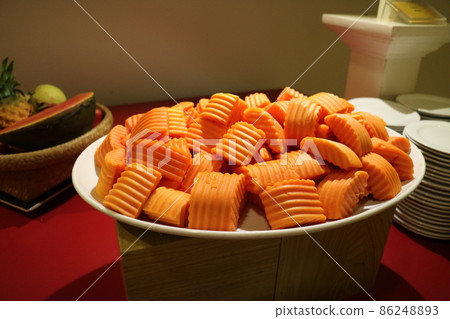 Chopped papaya fruit on a white plate 86248893