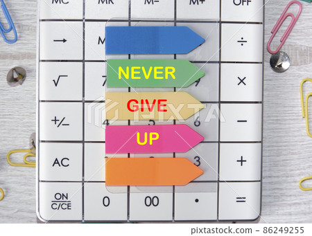 Never give up text is written on the stickers that are on the calculator Never give up text is written on the stickers that are on the calculator 86249255