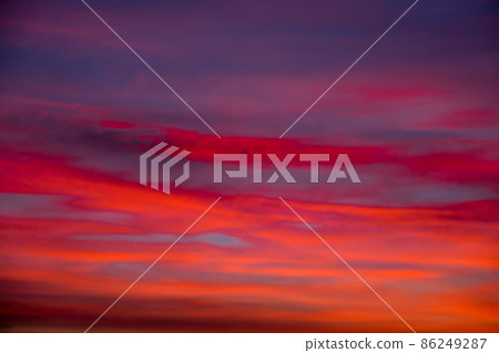 Vivid colourful clouds Dramatic Sky At Sunrise or Sunset. Orange red pink sky with beautiful clouds in sunlight background. Gradient cold to warm at sunset. Defocused abstract background Vivid colourful clouds Dramatic Sky At Sunrise or Sunset. Orange red pink sky with beautiful clouds in sunlight background. Gradient cold to warm at sunset. Defocused abstract background 86249287