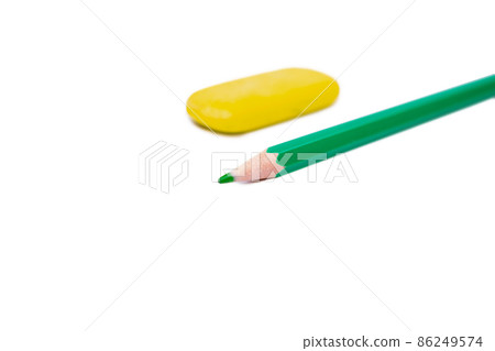 green pencil and yellow eraser on white background 86249574