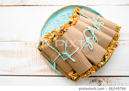 Delicious oatmeal bars with granola fruiots and nuts on blue plate 86249766