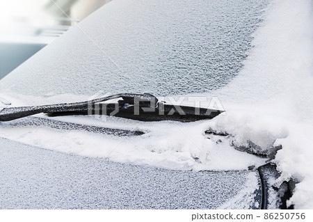 Ice on the windshield of the car. 86250756