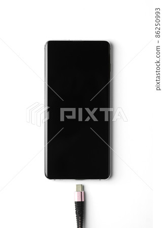 Smartphone and a charger on white background 86250993