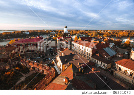 Aeral view of the Tower of St. Olaf and ruined Old cathedral in Vyborg from the Clock Tower in autumn 86251073