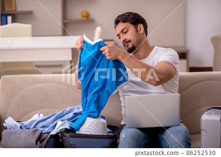 Young man preparing for trip at home 86252530