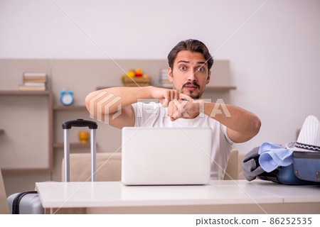 Young man preparing for trip at home Young man preparing for trip at home 86252535