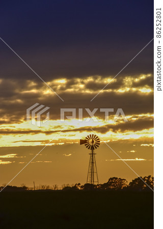 Landscape with windmill at sunset, Pampas, Patagonia,Argentina Landscape with windmill at sunset, Pampas, Patagonia,Argentina 86252801
