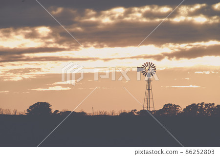 Landscape with windmill at sunset, Pampas, Patagonia,Argentina 86252803