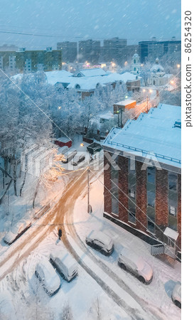 Winter snowy evening. Upper view on Grebnevskaya church and apartment buildings in Odintsovo, Russia. Winter snowy evening. Upper view on Grebnevskaya church and apartment buildings in Odintsovo, Russia. 86254320