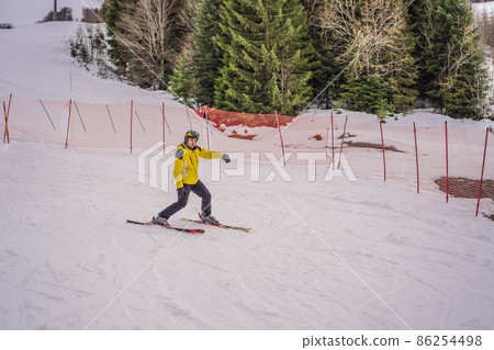 Ski instructor at training track showing students how to ski Ski instructor at training track showing students how to ski 86254498