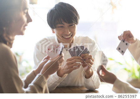 Young men and women enjoying playing cards 86255397