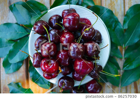 Berry Cherry on a wooden table rustic, top view. 86257030