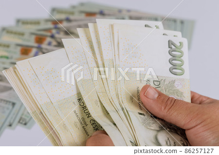 Close-up Czech koruna banknotes in man holding many banknote 86257127