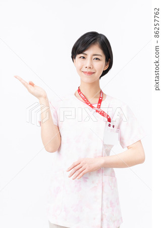 Young female nurse in pink floral scrub (white background) 86257762