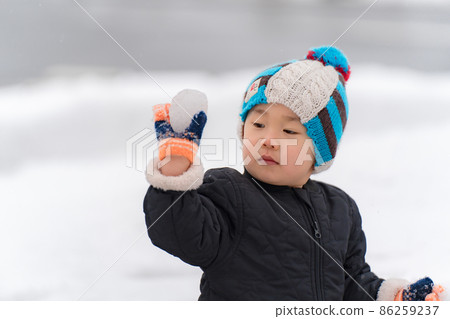 A child playing snow A child playing snow 86259237